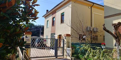 a house with a fence in front of it at B&B Itala in Recanati