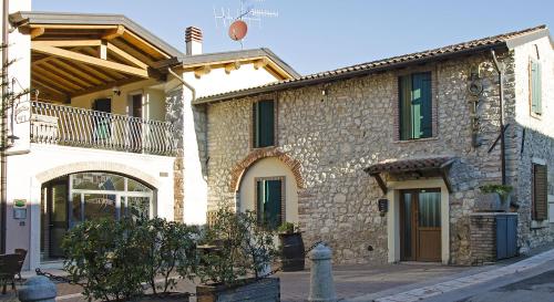 a large stone building with a balcony on it at Bed&Wine in Negrar