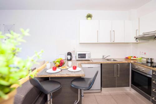 a small kitchen with a table and chairs in it at Lucile - Coralli Beachfront Apartment in Paralimni