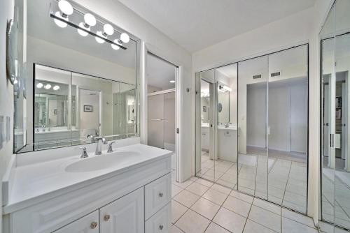 a bathroom with a sink and a large mirror at Atrium #201 in Sanibel
