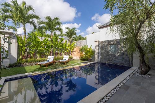 a swimming pool in the backyard of a house at Bali Voyage in Seminyak
