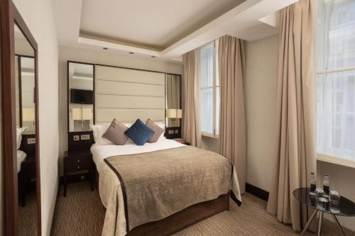 um quarto de hotel com uma cama e uma grande janela em Montcalm Brewery Townhouse em Londres
