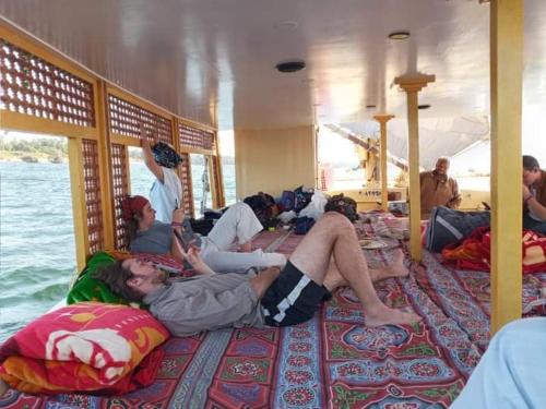 a group of people sleeping on a boat at Salah El Din Restaurant on the Nile Corniche in Aswan