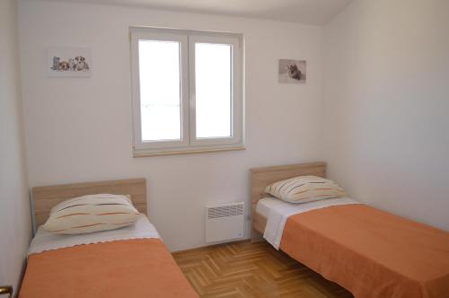 Posteľ alebo postele v izbe v ubytovaní Apartment Quattro