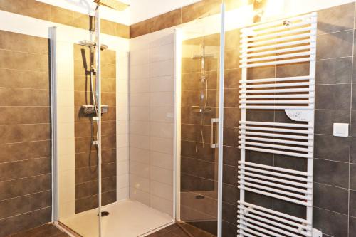 a bathroom with a shower with a glass door at Hotel Riviera in Bastia