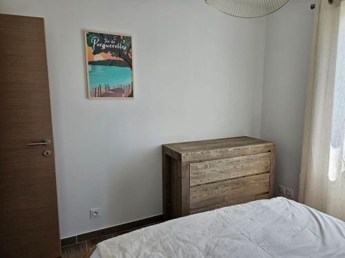 a bedroom with a bed and a wooden dresser at Maison en Provence avec piscine in Sainte-Tulle
