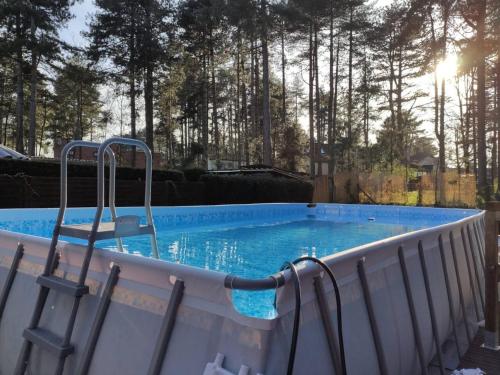 a swimming pool with two chairs in it at Villa de 4 chambres avec piscine privee sauna et terrasse a Quend in Quend