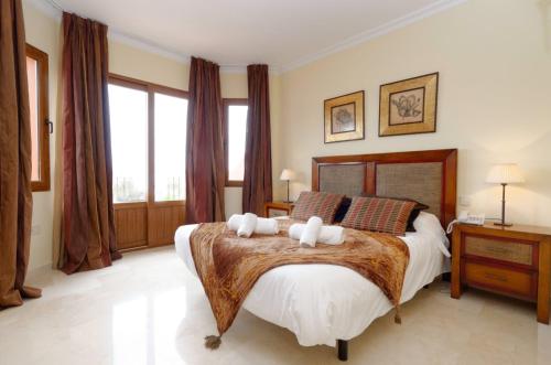 a bedroom with a large bed with two pillows at Paradise in la Manga Club in Murcia
