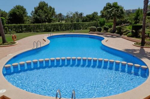 a large swimming pool in a yard with trees at Paradise in la Manga Club in Murcia