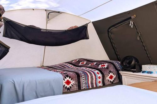 a room with a bed and a mirror at Moab RV Resort Glamping Setup Tent in RV Park #4 OK-T4 in Moab