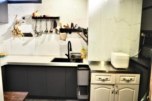 a small kitchen with a sink and a counter at One Zen Lodge Snowy Haven in Lijiang