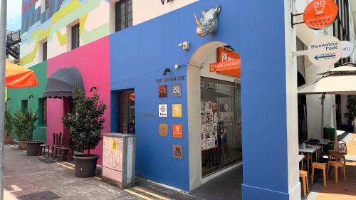 a colorful facade of a building with a restaurant at Bluewaters Pods 11 North Canal Road in Singapore