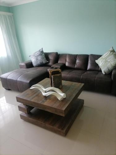 a living room with a couch and a coffee table at Busap in Port Shepstone