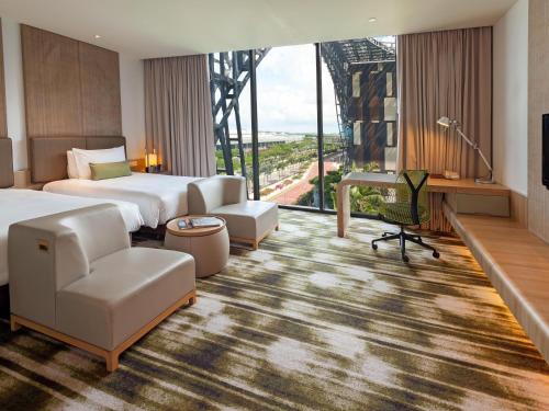 a hotel room with a bed and a desk at Crowne Plaza Changi Airport by IHG in Singapore