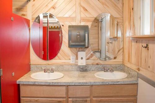 a bathroom with two sinks and a tv at Moab RV Resort Outdoor Glamping Destination RV OK40 in Moab