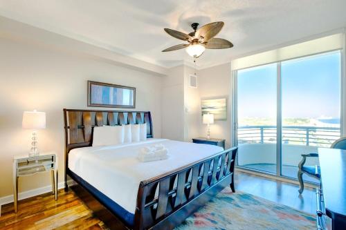 a bedroom with a bed and a ceiling fan at Ocean Club 1607 in Biloxi