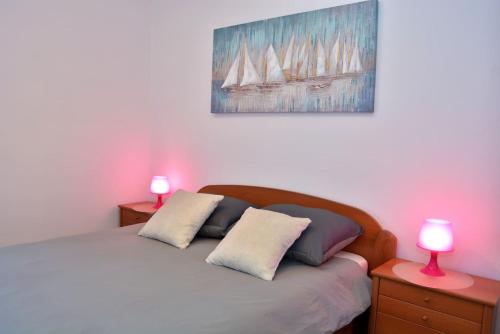 a bedroom with a bed with two lamps on tables at LILI KALI in Kali