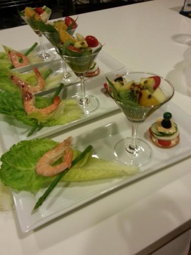 a table with three plates of food and wine glasses at Hou Niao Fei Xing B&B in Taiping