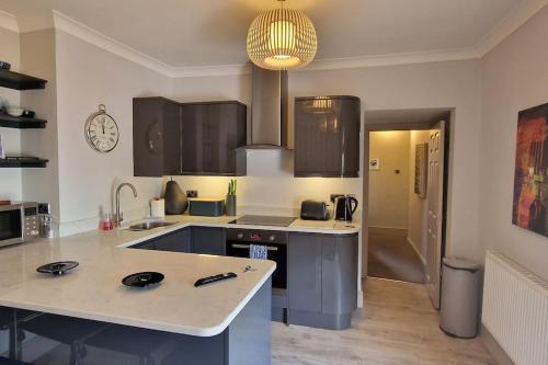a kitchen with a sink and a counter top at Pear Apartment York City Centre - Self Check-in in York