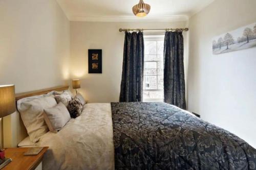 a bedroom with a bed and a window at Pear Apartment York City Centre - Self Check-in in York