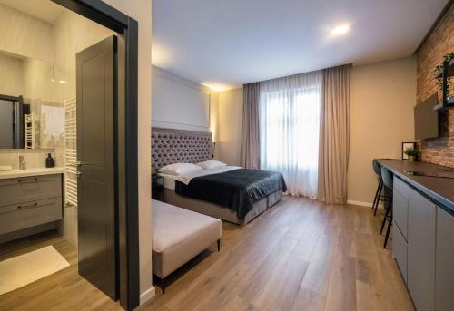 a hotel room with two beds and a bathroom at Imperial Apartment B in Zagreb