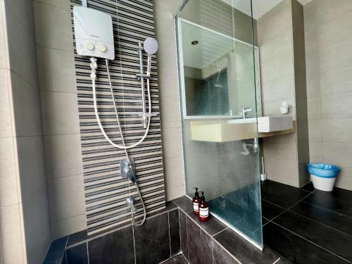 a bathroom with a shower and a sink and a mirror at Setapak Cozy 4-6 Pax Suite ZetaPark by CITYSPACE in Kuala Lumpur