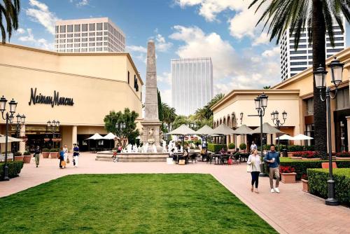 a rendering of a mall with a fountain in a park at Datu - Discover world with us in Newport Beach