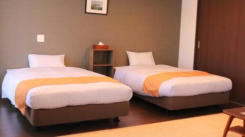 Postel nebo postele na pokoji v ubytování Apartment Hotel Ecott