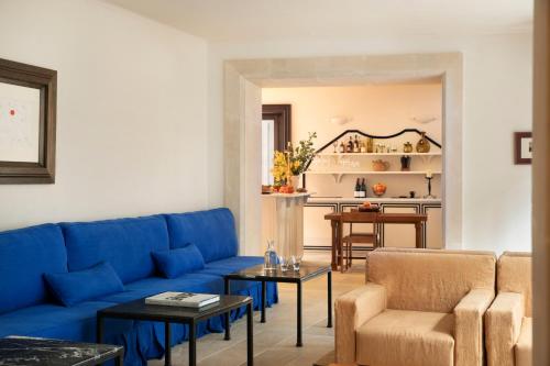 a living room with a blue couch and chairs at Portella in Palma de Mallorca