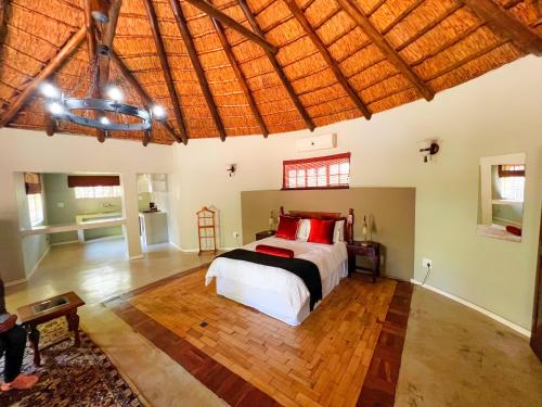a bedroom with a bed and a wooden floor at Protea Ridge Guest Cottages and Conference Centre in Roodepoort