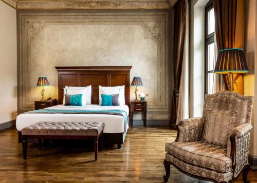 a bedroom with a bed and a chair at Palazzo Donizetti Hotel - Special Class in Istanbul
