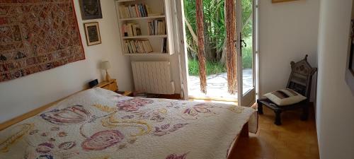 1 dormitorio con 1 cama y puerta corredera de cristal en Villa conviviale au soleil avec piscine, en Seillans