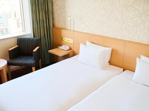 Un ou plusieurs lits dans un hébergement de l'établissement Tobu Hotel Levant Tokyo