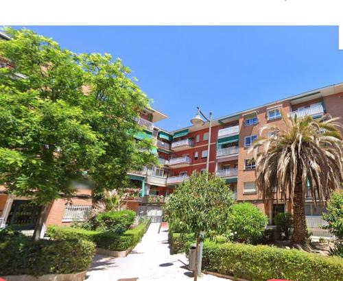 an apartment building with trees and bushes in front of it at Golden line in Alcobendas