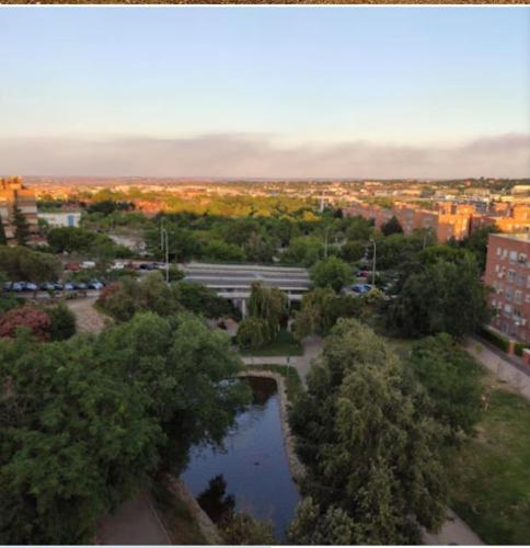 an aerial view of a city with a river at Golden line in Alcobendas