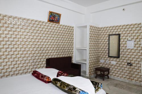 um quarto com 2 camas e uma parede em Govind Priya ashram em Vrindavan