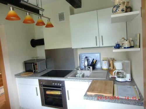 a kitchen with a sink and a stove top oven at Ferienhaus Schöne in Lebbin