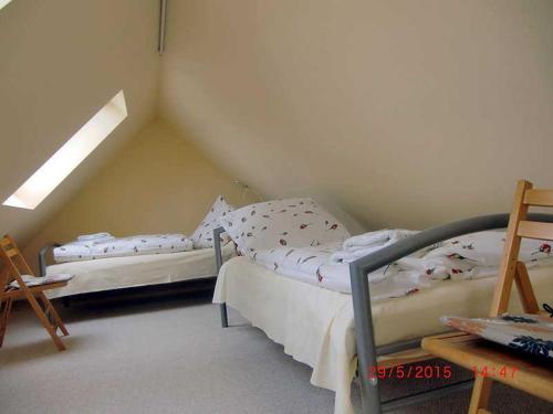 a bedroom with two beds in a attic at Ferienhaus Schöne in Lebbin