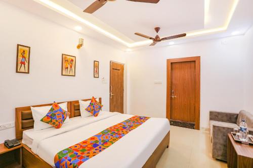 a bedroom with a large bed and a ceiling fan at FabHotel Duke Inn in Bhopal
