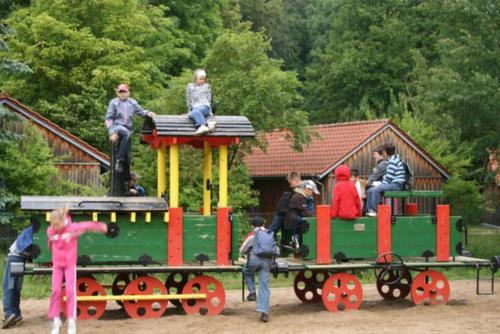 a group of people sitting on a toy train at Schullandheim in Neubrandenburg