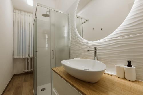 a bathroom with a white sink and a shower at Exphome in Novate Milanese
