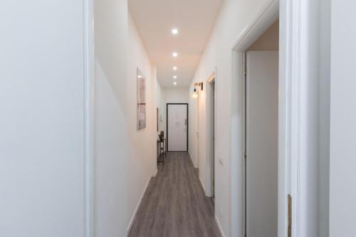 a hallway with white walls and wood floors at Exphome in Novate Milanese