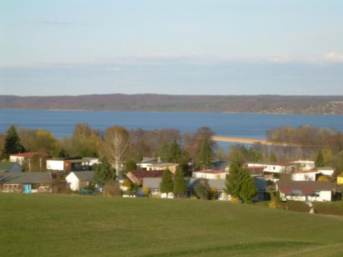 a small town with a lake in the background at Bungalow "Sonnenschein" in Wustrow