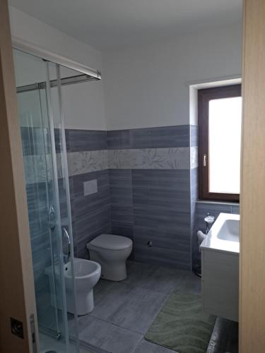 a bathroom with a toilet and a sink at Cappuccini Guest House in San Giovanni in Fiore