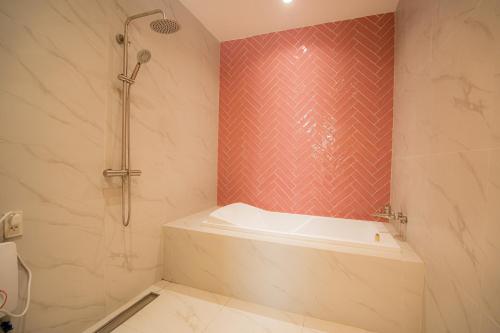 a bathroom with a shower and a bath tub at JVJ HOTELS CORPORATION in Batangas City