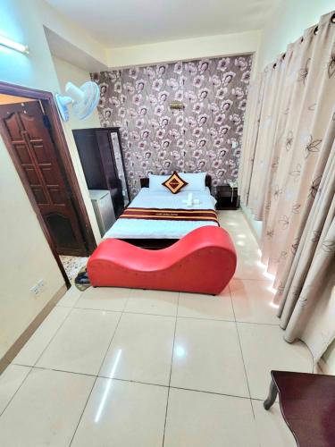 a bedroom with a red bed in the middle at Tuấn Hưng Hotel HCM in Ho Chi Minh City