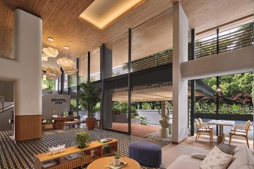 an open living room with a lot of windows at ARTOTEL Casa Kuningan in Jakarta