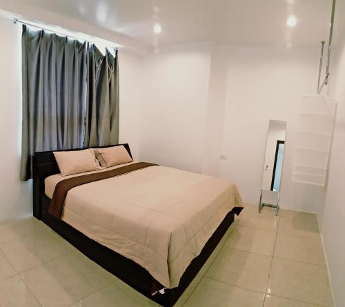 a bedroom with a bed and a window at 2-Bedroom Condo with City Skyline View in Vientiane