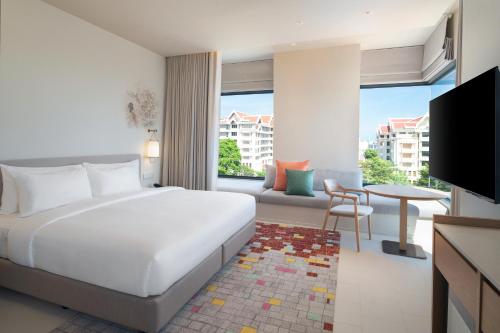 a bedroom with a bed and a living room at Centara Ayutthaya in Phra Nakhon Si Ayutthaya