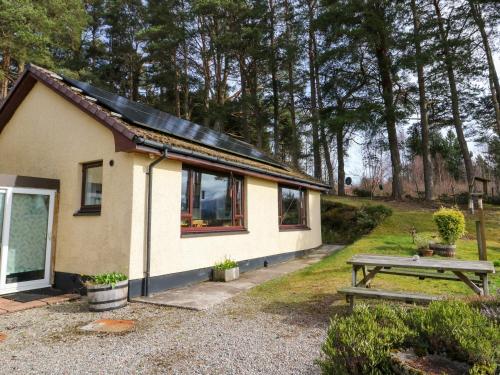 a small house with a picnic table in front of it at Alba Ben View in Spean Bridge